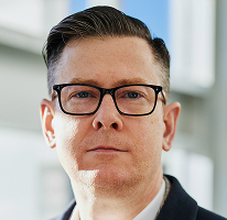 Alexander Hughes, CEO and executive heading a crypto trading company, portrait